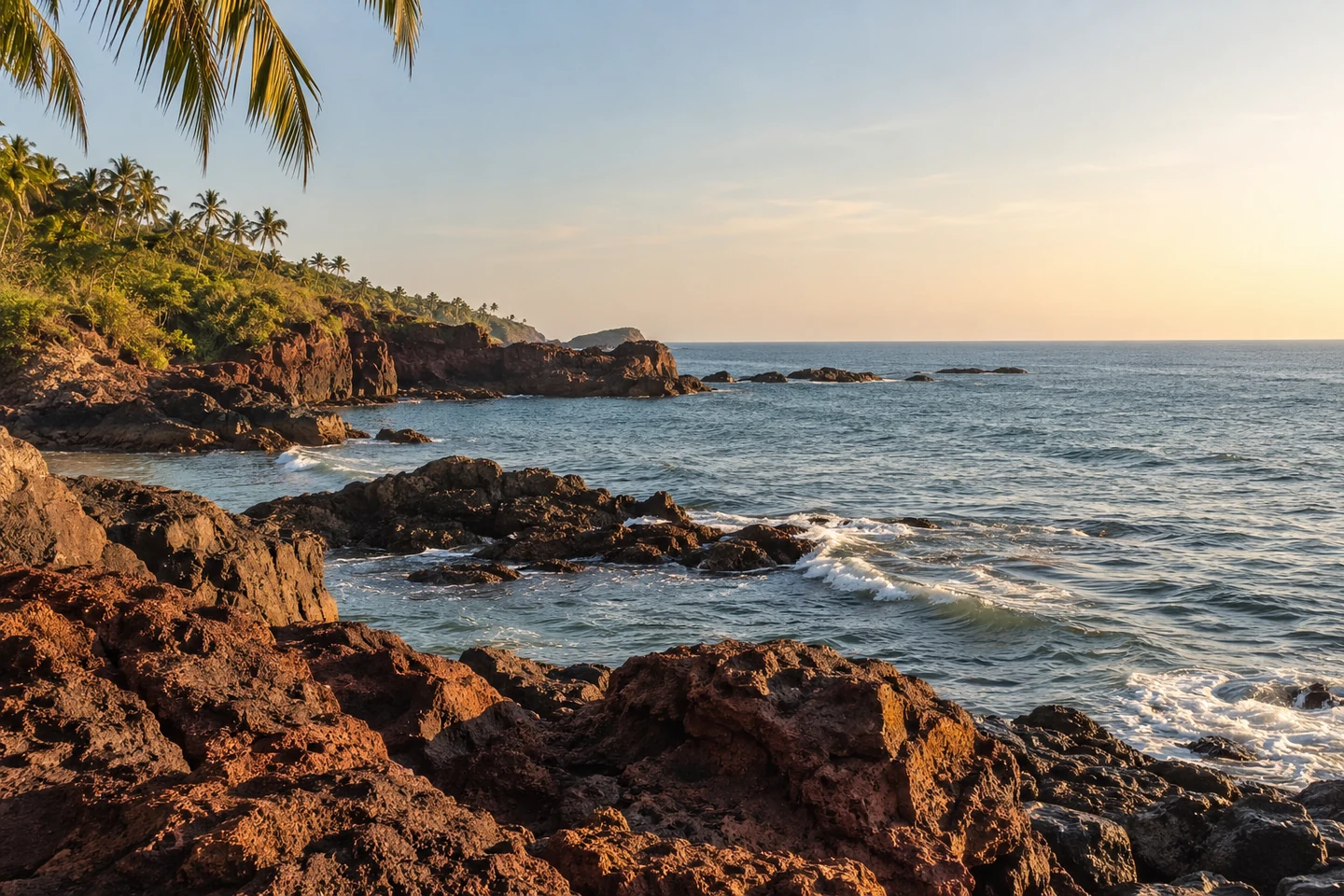 Illustrative coastal cove with late afternoon light on laterite rocks