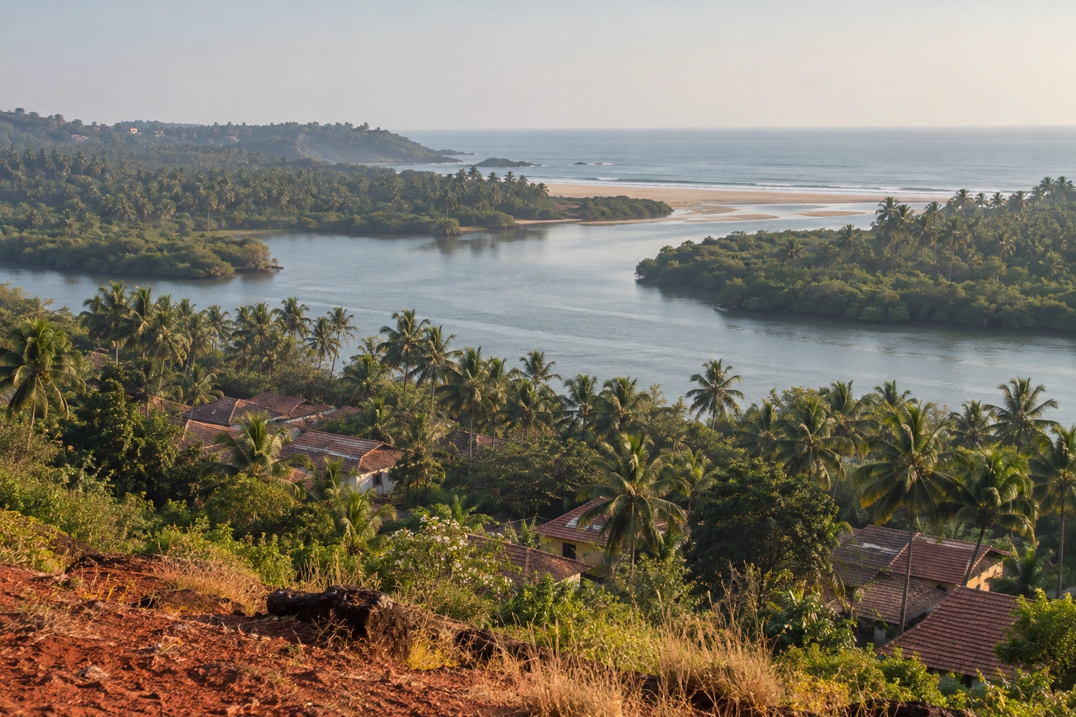 An illustrative Goan village landscape with palms, a tidal river and the coast beyond